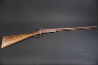 a rifle with a wooden barrel on a black background