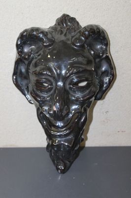 statue of a man ' s head with a goat ' s head in the middle