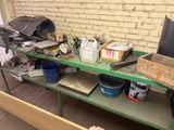 a man that is standing in front of a table with tools