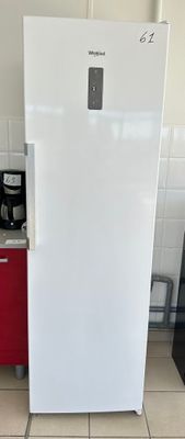 a white refrigerator in a kitchen with a red cabinet