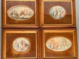 four framed pictures of a group of people on a wall