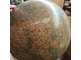 a person holding a large globe in their hand