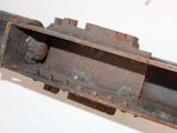 a close up of a rusted metal object on a white surface