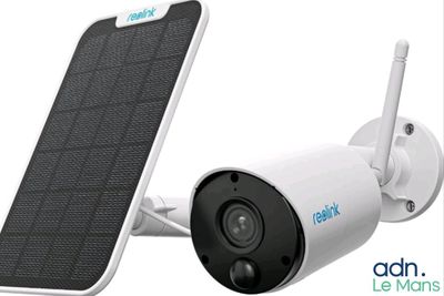 a close up of a solar powered security camera attached to a wall