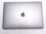 a silver apple laptop with a skull on the screen
