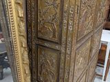 a large ornate gold chest of drawers in a room