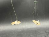 two pieces of wood hanging from the ceiling of a room