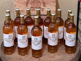 several bottles of wine are lined up on a wooden table