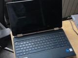 a laptop computer sitting on a desk next to a chair