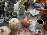 a table that has a lot of dishes and cups on it