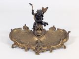 a bronze statue of a boy on top of a shield