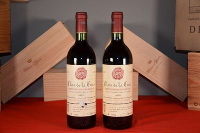 two bottles of wine sitting next to each other on a table