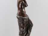 bronze statue of a woman holding her head in her hands