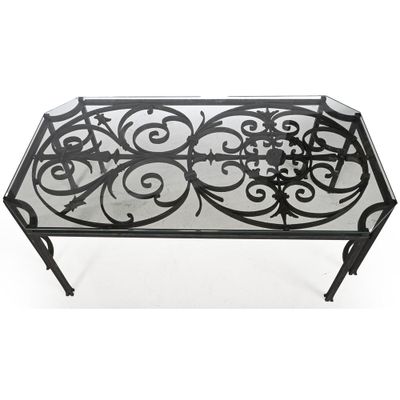 table basse en fer forgé avec plateau en verre et motif en volutes