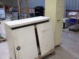 a refrigerator and a freezer sitting in a warehouse