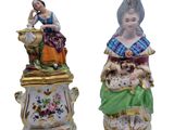 pair of porcelain figurines of a woman and a dog