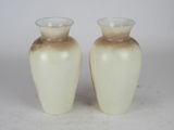 two vases that are sitting on a table