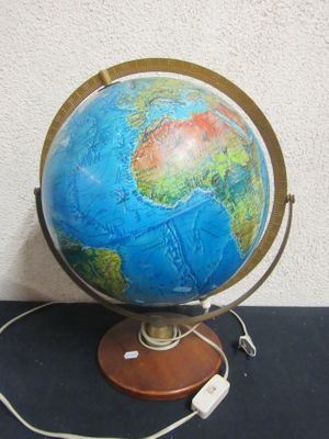 a small blue and green globe on a wooden stand