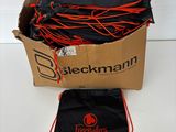 a box filled with black and orange bags sitting on top of a table