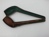 a green case with a wooden handle on a white surface