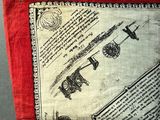 a red and white pillow with a picture of a plane on it