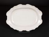 an image of a white plate sitting on top of a black table