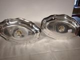 pair of silver plated dishes on a table with a white background