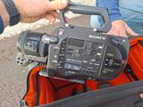 a person holding a video camera in a bag