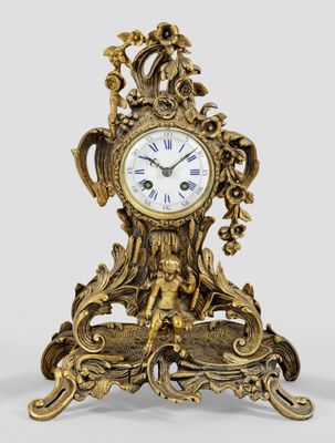 a gold clock that is sitting on a table