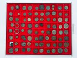 a red display case with a lot of coins in it