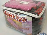 a bag of pink and black bedding on a white table