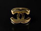a close up of a gold ring on a black surface