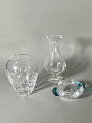 three glass vases sitting on a table next to each other