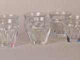 four glasses sitting next to each other on a table