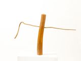 a wooden cross on top of a white pedestal