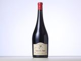 the bottle of red wine is sitting on the table