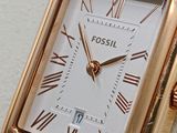 a gold watch with roman numerals on the face of it