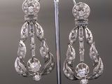an image of a pair of diamond earrings on a stand
