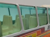 a toy bus that is sitting next to a building