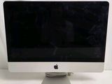 a white apple desktop computer sitting on a table