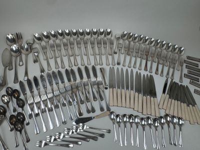 a lot of silver spoons and spoons on the table