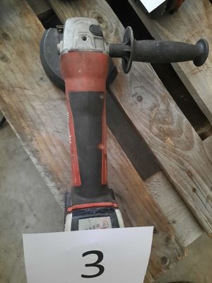a picture of a corded drill on a wooden table