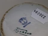 a white plate with a blue and green design on it