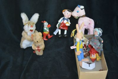 many stuffed animals in a box on a black background