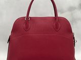 a red leather handbag on a white background