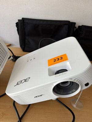 a small projector sitting on top of a table next to a bag