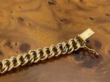 an image of a wooden table with a gold chain on it