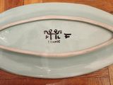 a plate that has a handle on it on a wooden table