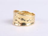 a close up of a gold ring on a white surface