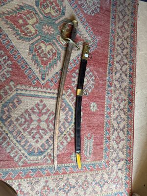 a picture of a knife and a sword on a rug